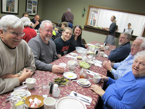 Locals and Visitors gather around long tables together to enjoy Chicken Pot Pie and all the fixings.